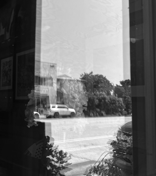 A picture of the street reflected on a window